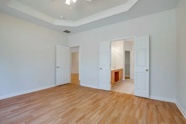 Primary bedroom with a trey ceiling