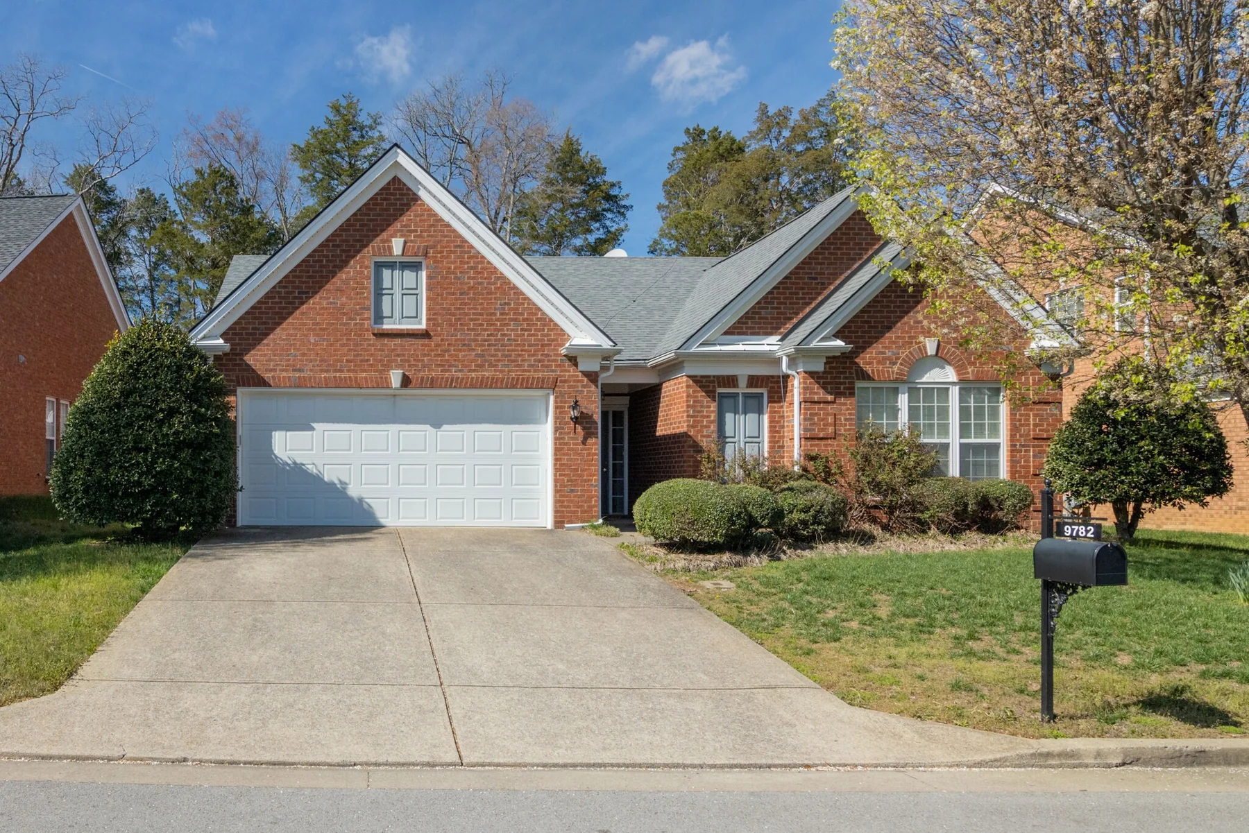 Front elevation of 9782 Jupiter Forest Drive — a brick single-story home